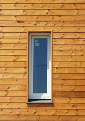 Plastic PVC Window in New Modern Passive Wooden House Facade Wall. PVC Windows are the Number One in Energy Efficiency.