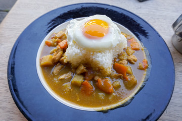 Indian food beef with Fried Egg on the rice in the dish. horizon