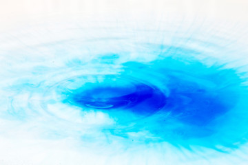 Paint drop splashing on black a background