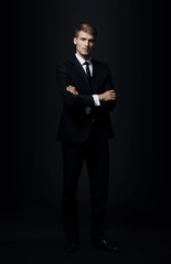 Full-length portrait of business man  isolated on black backgrou