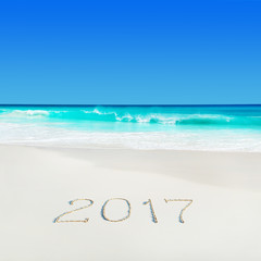 Fototapeta na wymiar Perect white sand ocean beach and year 2017 season caption