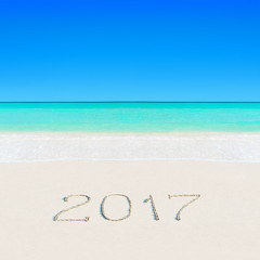 Happy New Year 2017 on sandy ocean tropical summer beach