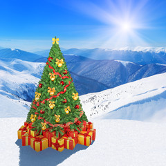 Christmas tree in winter snow mountains against sunshine sky background