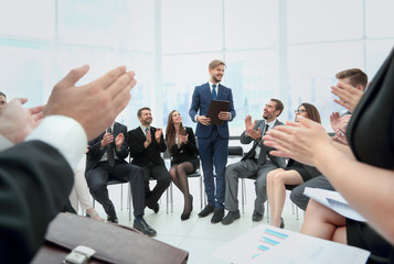 Business group greets leader with clapping and smiling