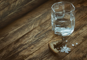 glass of water, crust of black bread, salt
