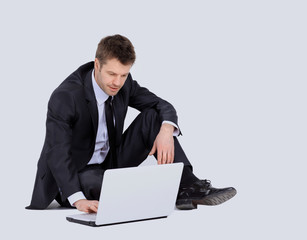 Businessman with laptop isolated on white background