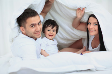 Attractive young family in the bedroom