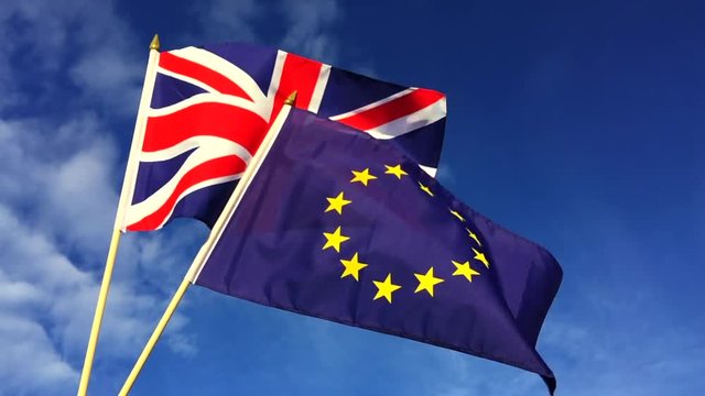 European Union and British Union Jack flag flying in front of bright blue sky in representation of the Brexit EU referendum