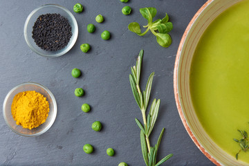 food background of Pureed pea soup with spices, fresh mint and garlic (vegan, vegetarian)