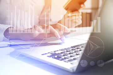 Woman's hands using touchpad and graphs