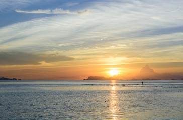 Naklejka na ściany i meble Beautiful sunset with blue sea and sky background