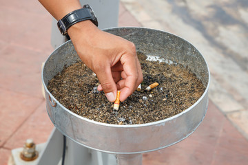 Hand holding burning cigarette