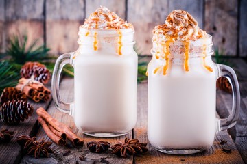 Christmas drink: hot white chocolate with whipped cream and caramel in mason jars - Powered by Adobe