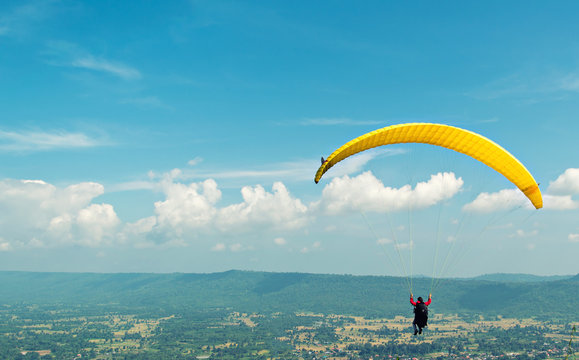 One woman paragliding during autumn evenings, beautiful landscape. Thailand . The challenge courage