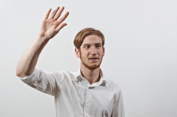 Young Adult Male in White Shirt Gesturing, Waving His Hand