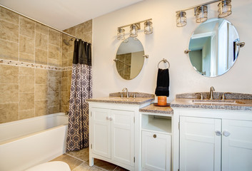 Bathroom detail. Vanity cabinet with a shower.