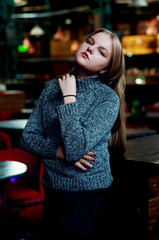 Thoughtful young woman in dim lit cabaret