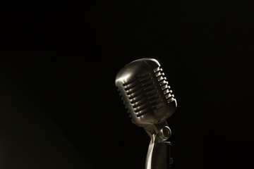 old style 55 microphone on stage black bg looking room