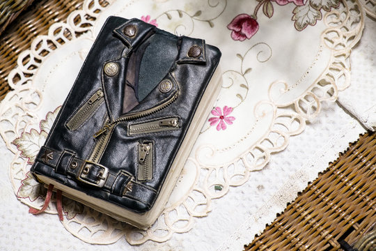 vintage leather jacket style bible cover on the table. Mini biker bible jacket.