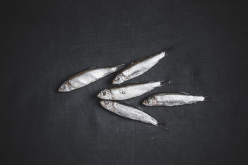 Fish. Herring on the table, dark background. Place for text. Dried.