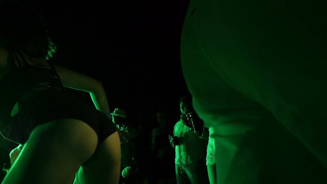Twitching legs and booty dancing girl close up on stage in club