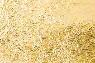 Gold wrinkled paper texture abstract background