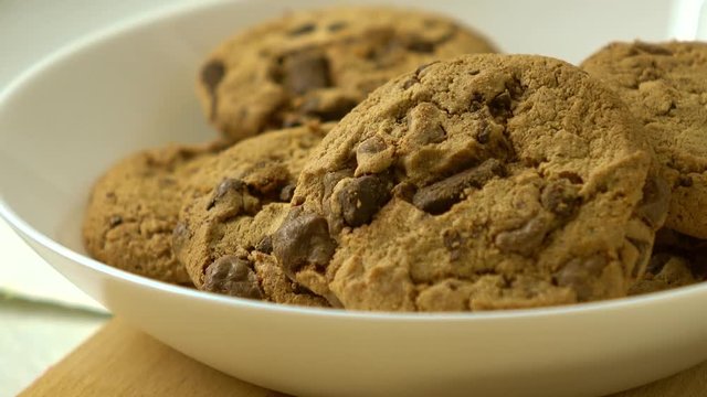 Chocolate chip cookies and glass of milk for breakfast 4K close-up racking focus shot