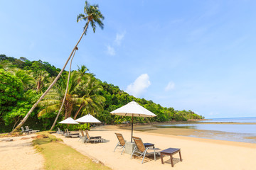 Coconut tree and beach wooden bed on white sand with beautiful b