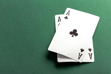 Cards and chips for poker on green table