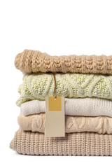 Stack of various sweaters isolated on white background