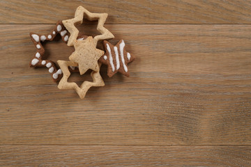 star shaped gingerbread and chocolate cookies on wooden background