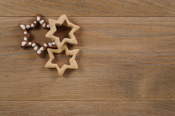 star shaped gingerbread and chocolate cookies on wooden background