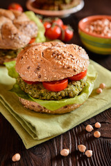 Vegetable burger with chickpeas - spinach fritter, lettuce and tomato