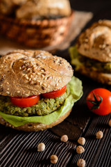 Vegetable burger with chickpeas - spinach fritter, lettuce and tomato