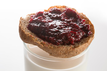 Toasted bread with layer of black currant jam on top of colorles