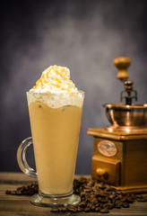 Iced coffee cafe latte with cream on the vintage wood
