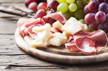 Antipasto with grape, cheese and ham