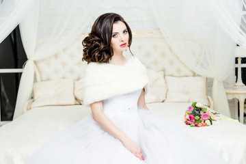Obraz na płótnie Canvas gorgeous bride in luxury wedding dress. Bride. Perfect Make up. Hairstyle, wedding jewelry. Beautiful Woman with Shiny Brown Hair. gorgeous wedding bouquet of various flowers.