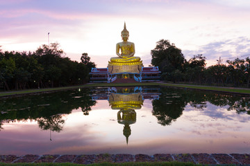 Golden Buddha images on sky clouds background in evening. Golden Buddha statue in a Buddhist temple