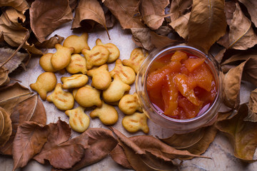  quince jam and small biscuits,  autumn leaves, glass bowl 