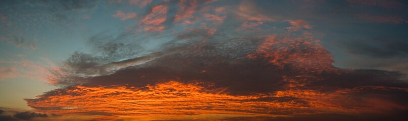 Naklejka na ściany i meble Panorama of a twilight sky Beauty Evening colorful clouds - sunlight with dramatic sky