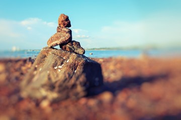 A pile of a well balanced rocks on the beach usable for simple backgrounds or balance and meditation concepts.