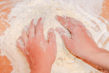 Girl's hand with the dough.