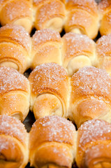 Fresh croissant on wooden background.