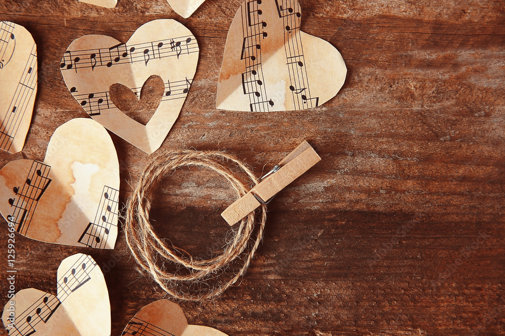 Sticker Paper hearts with music notes on wooden background