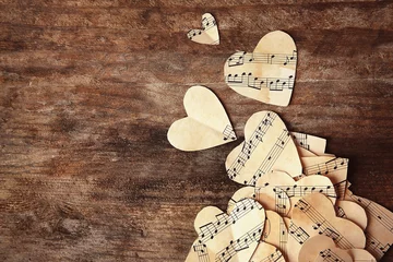 Zelfklevend Fotobehang Paper hearts with music notes on wooden background © Africa Studio