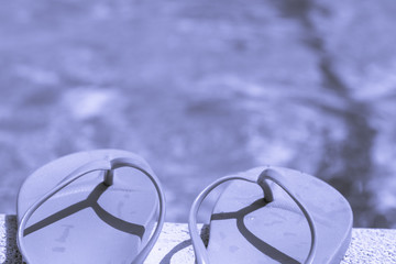 Blue flip flops on pool