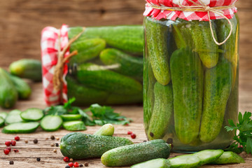 Fresh Cucumbers for pickling and marinated cucumbers in glass jars.