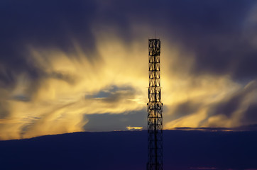 Radio, TV tower on the sunset background