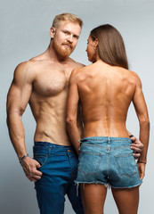 caucasian couple topless woman and brutal man with beard in jeans isolated on studio background